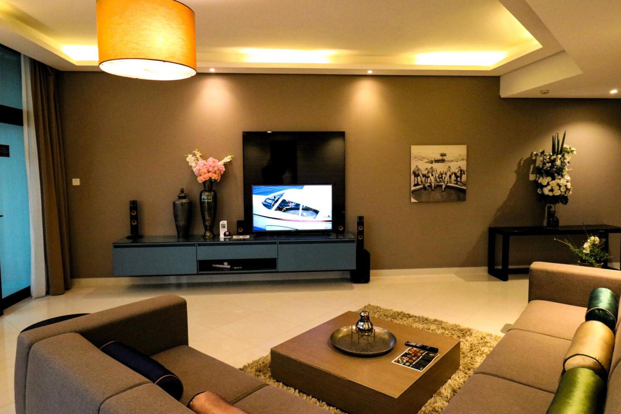 Lagoona Beach Luxury Resort And Spa Manama Exterior photo The photo shows a modern living room with a neutral color palette. Key features include:

- A comfortable seating area with a sofa arranged around a coffee table.
- A minimalist coffee table with a decorative item on top.
- A large flat-screen televi